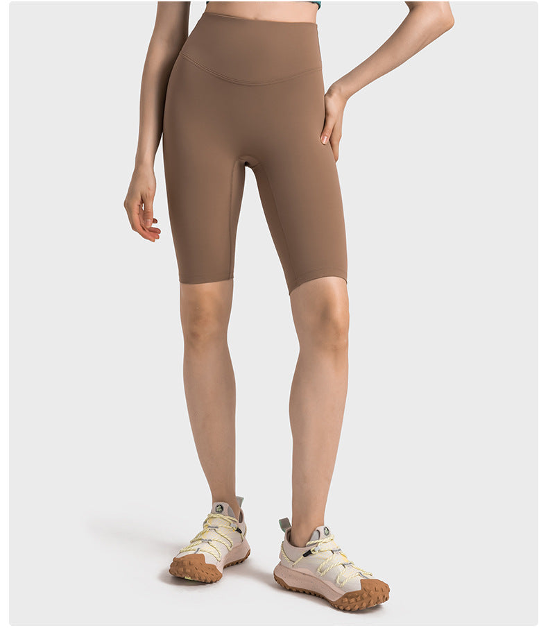 Front view of brown high-waisted yoga pants on model