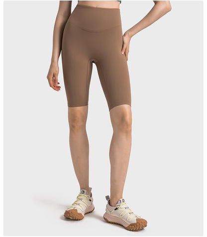 Front view of brown high-waisted yoga pants on model