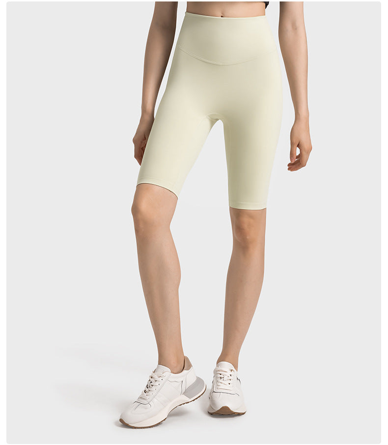 Front view of light yellow high-waisted yoga pants on model