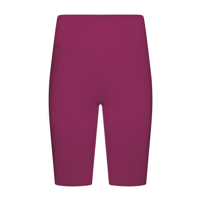 Front view of pink yoga shorts on model