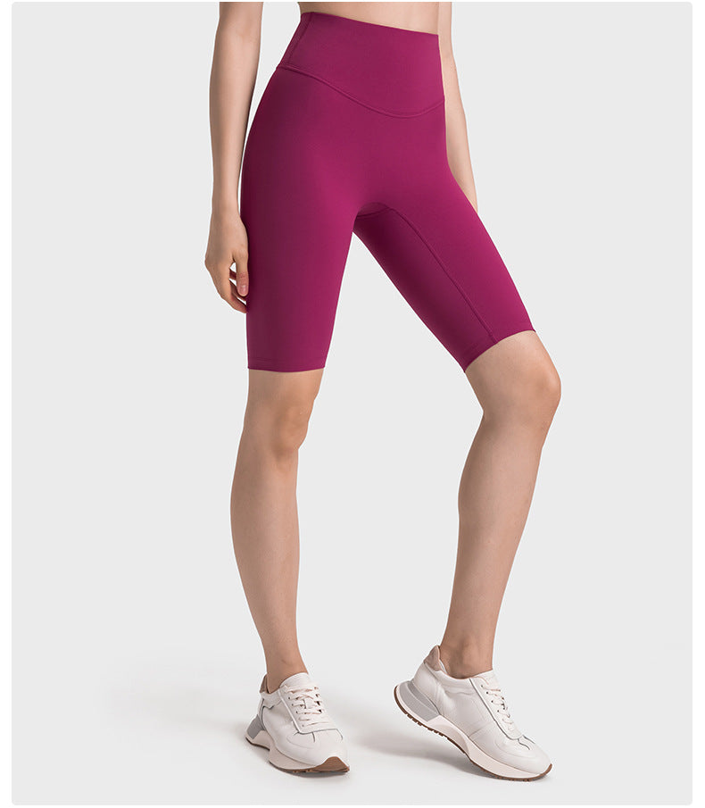 Side view of pink high-waisted yoga pants on model