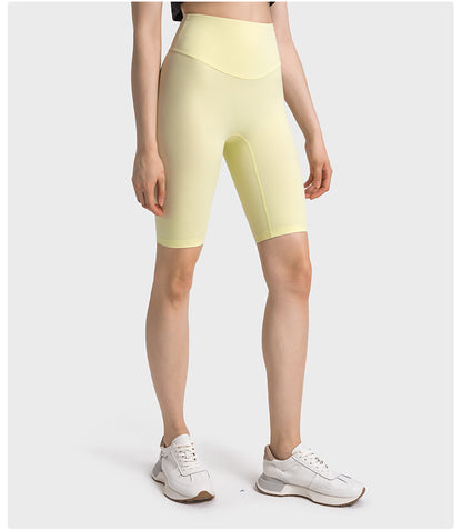 Side view of yellow high-waisted yoga pants on model