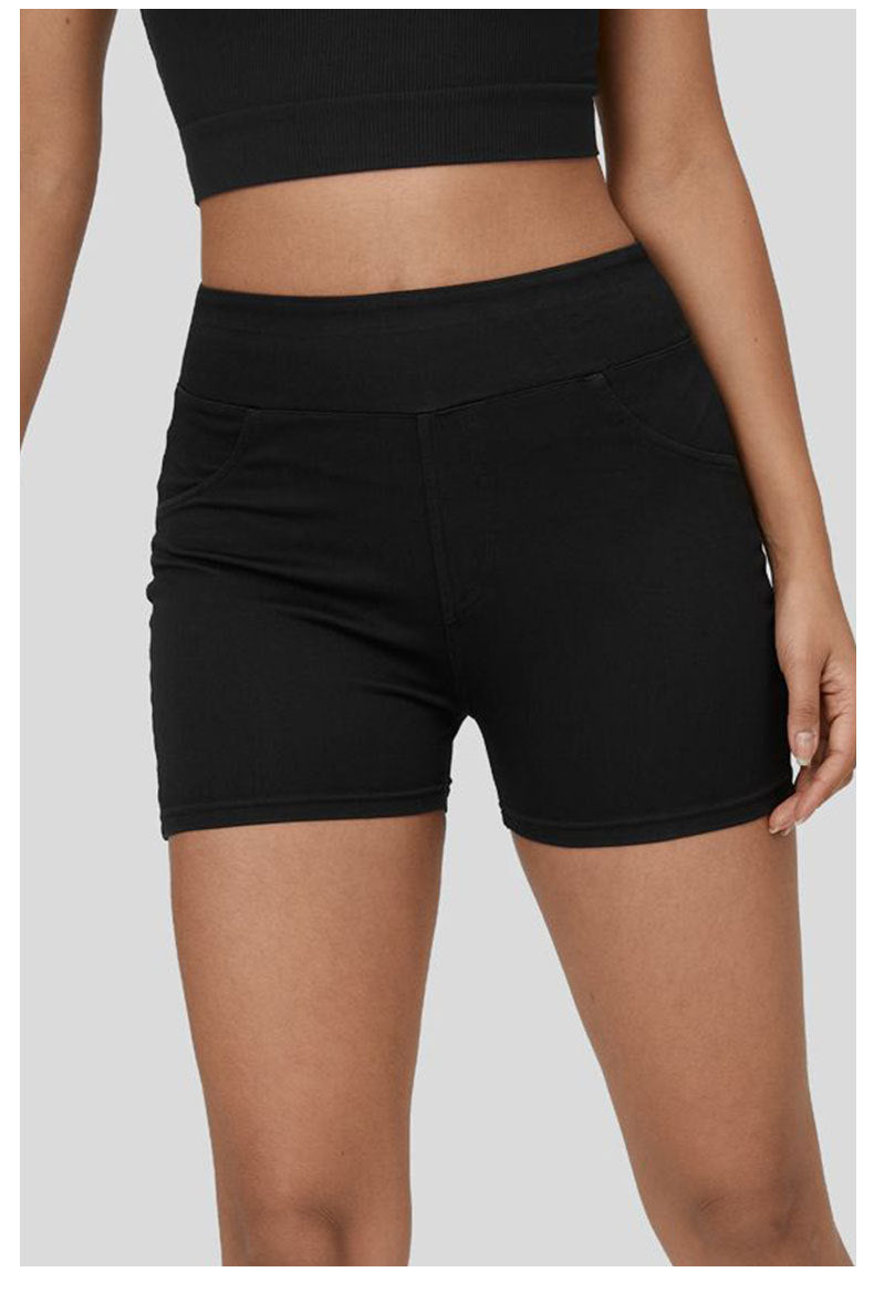 Slim fit denim yoga shorts styled with tank top

