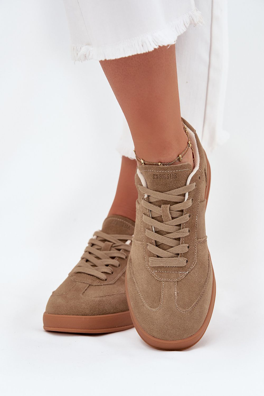 beige sport shoes detail view